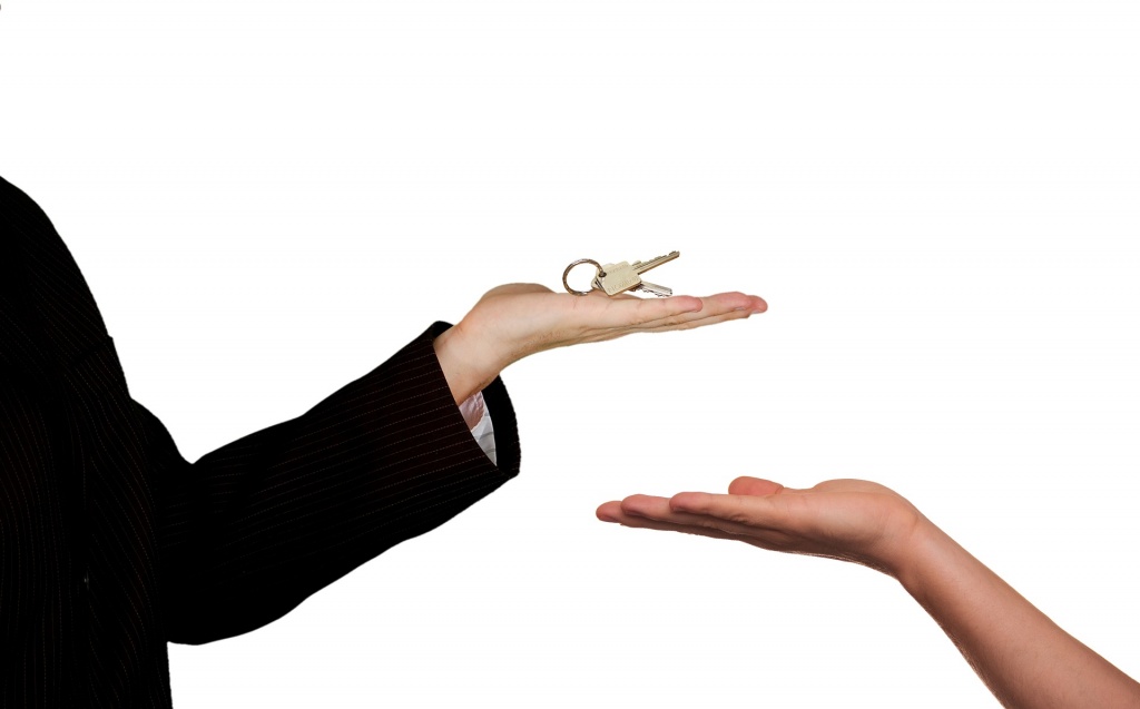 One person giving a key to another