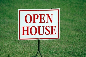 An open house sign on grass