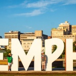 A big Memphis sign with two people standing in front of it.