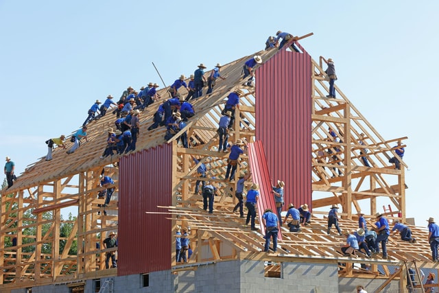Construction workers building a house.
