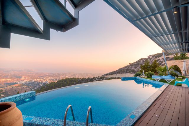 A luxury house with a pool and a view of the city. 
